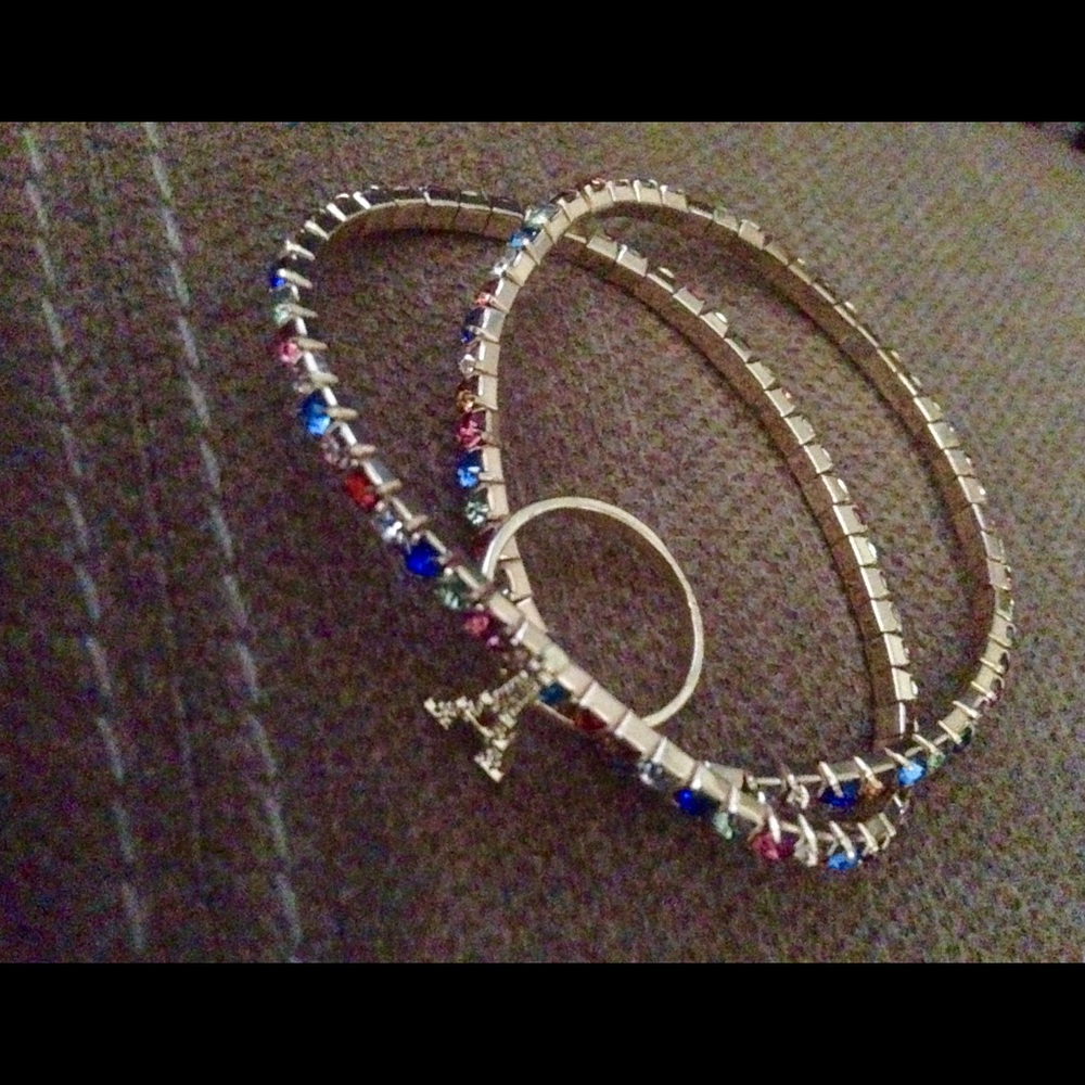 Two multi-colored sparkly bracelets and pinky ring